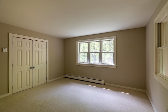 258 Densmore Hill Rd, Hartland, VT 05048 - unfurnished bedroom with a baseboard radiator, light colored carpet, a closet, and baseboards