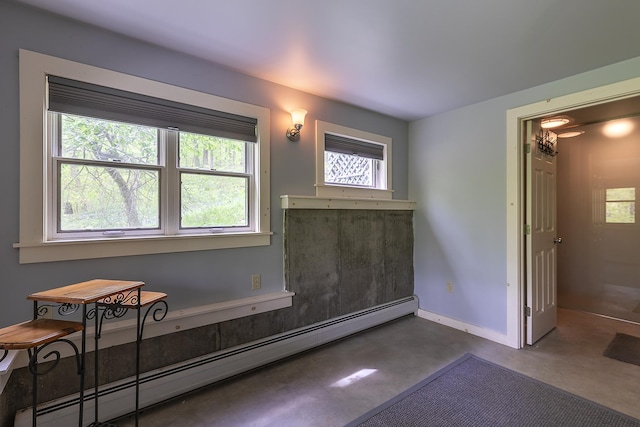 258 Densmore Hill Rd, Hartland, VT 05048 - unfurnished room with baseboard heating, finished concrete flooring, and baseboards