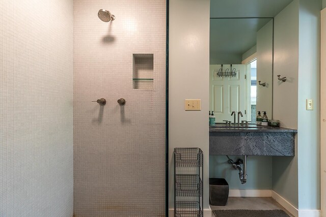 258 Densmore Hill Rd, Hartland, VT 05048 - bathroom with a tile shower, baseboards, and a sink