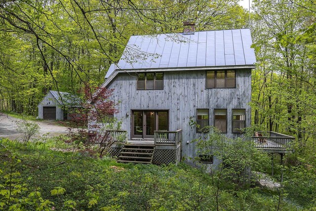 258 Densmore Hill Rd, Hartland, VT 05048 - rear view of house with a standing seam roof, a chimney, a wooden deck, and metal roof