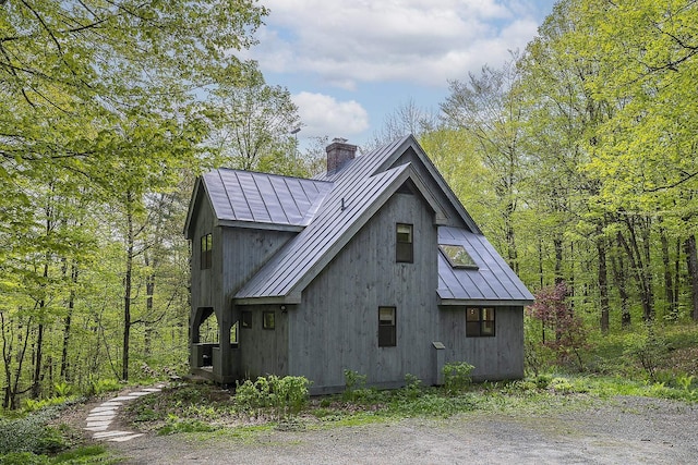 258 Densmore Hill Rd, Hartland, VT 05048 - view of property exterior featuring a chimney, metal roof, and a standing seam roof