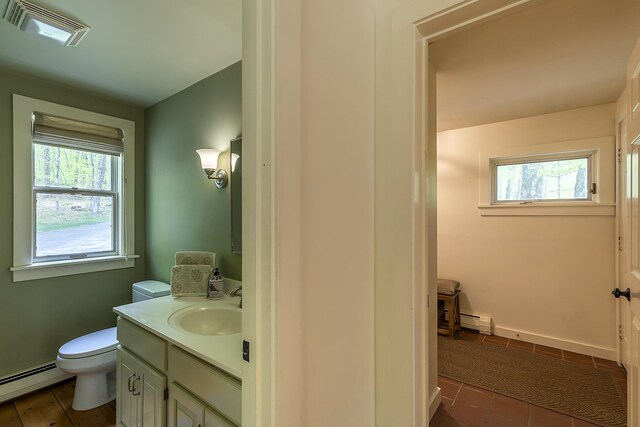 258 Densmore Hill Rd, Hartland, VT 05048 - bathroom featuring a baseboard heating unit, toilet, and plenty of natural light