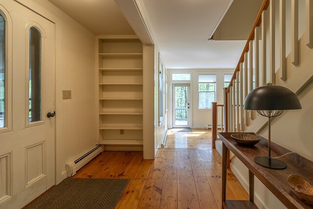 258 Densmore Hill Rd, Hartland, VT 05048 - entryway featuring a baseboard heating unit, light wood finished floors, stairs, and baseboards