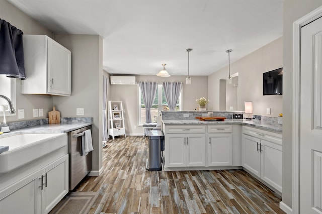 32 David Lewis Rd, Gilford, NH 03249 - kitchen featuring a peninsula, stainless steel dishwasher, dark wood-style floors, white cabinetry, and a wall unit AC