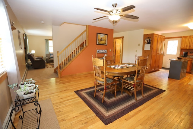 412 Covered Bridge Rd, Irasburg, VT 05845 - dining room with stairway, a ceiling fan, and light wood-style floors