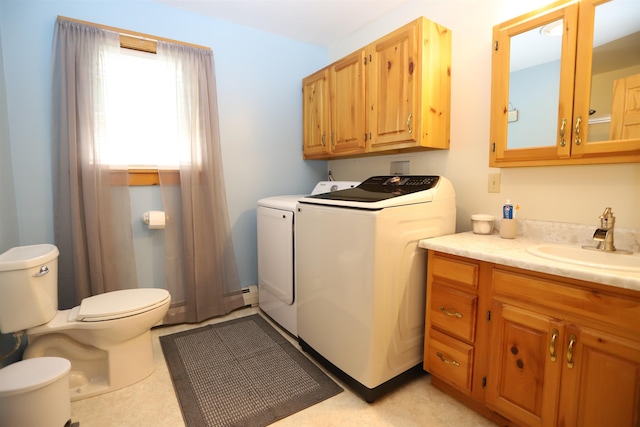 412 Covered Bridge Rd, Irasburg, VT 05845 - washroom featuring a sink, washer and dryer, and a baseboard heating unit