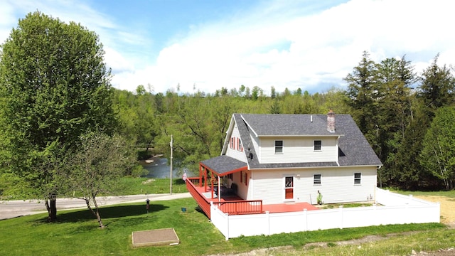 412 Covered Bridge Rd, Irasburg, VT 05845 - back of house with a wooded view, a chimney, a deck, and a shingled roof