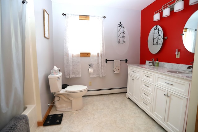 412 Covered Bridge Rd, Irasburg, VT 05845 - bathroom featuring a baseboard heating unit, toilet, double vanity, and baseboards