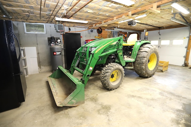 412 Covered Bridge Rd, Irasburg, VT 05845 - garage with freestanding refrigerator and a garage door opener