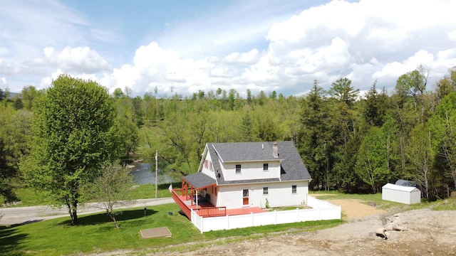412 Covered Bridge Rd, Irasburg, VT 05845 - rear view of house with a deck, a wooded view, an outbuilding, a storage shed, and a lawn