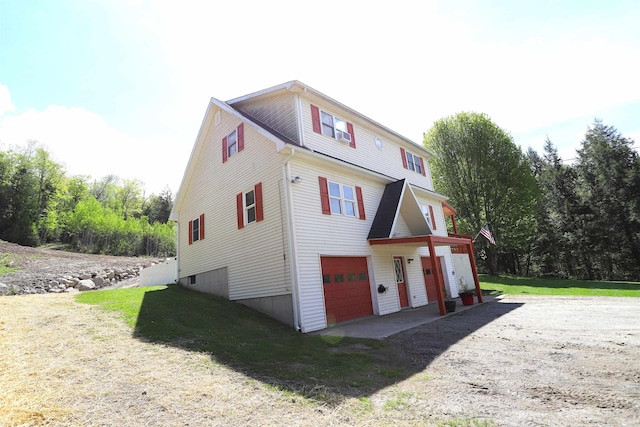 412 Covered Bridge Rd, Irasburg, VT 05845 - view of property exterior with a garage, a yard, and dirt driveway