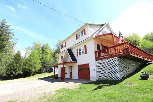 412 Covered Bridge Rd, Irasburg, VT 05845 - view of side of home with driveway, a yard, an attached garage, and a wooden deck