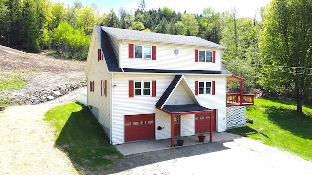 412 Covered Bridge Rd, Irasburg, VT 05845 - traditional-style house featuring a front lawn, a forest view, driveway, and roof with shingles