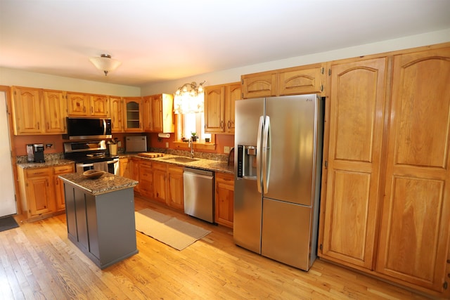 412 Covered Bridge Rd, Irasburg, VT 05845 - kitchen featuring stainless steel appliances, dark stone counters, a sink, and light wood-style flooring