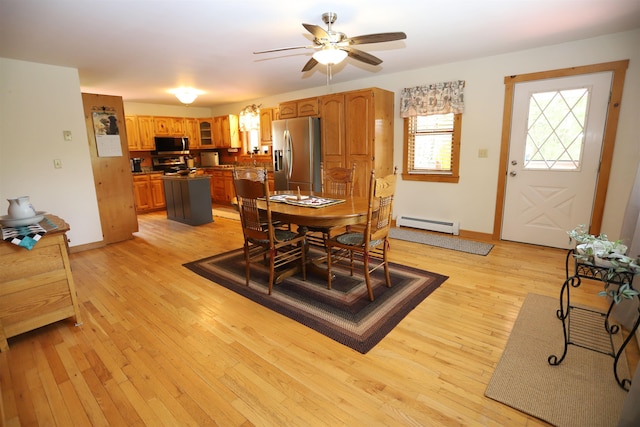 412 Covered Bridge Rd, Irasburg, VT 05845 - dining area featuring a baseboard heating unit, a ceiling fan, light wood-type flooring, and baseboards