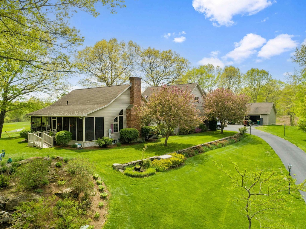117 Tavern Rd, Fremont, NH 03044 - view of grassy yard with a sunroom and an outbuilding