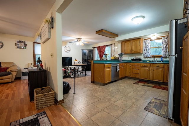 175 Blackwater Rd, Somersworth, NH 03878 - kitchen featuring open floor plan, stainless steel appliances, a peninsula, a sink, and dark countertops