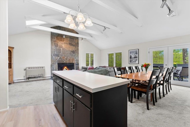 6 Roundtree Rd, Winhall, VT 05340 - kitchen with light countertops, rail lighting, a chandelier, and a fireplace