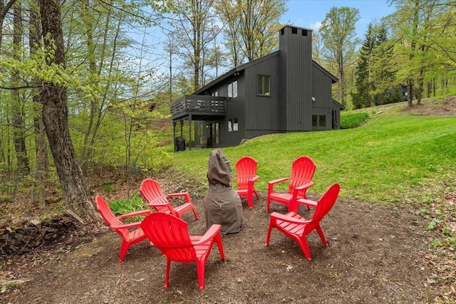 6 Roundtree Rd, Winhall, VT 05340 - view of grassy yard with a deck and an outdoor fire pit