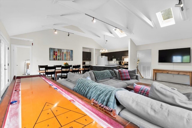 6 Roundtree Rd, Winhall, VT 05340 - living area featuring a skylight, rail lighting, beamed ceiling, and high vaulted ceiling