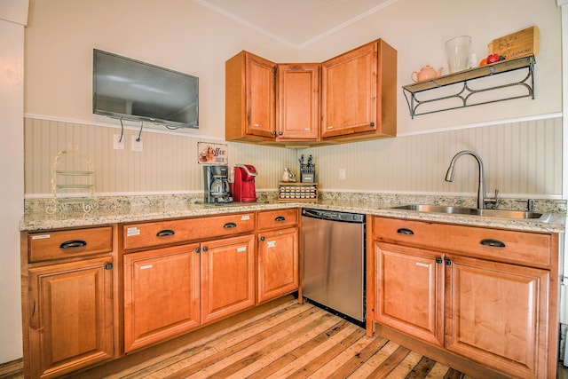 56 Andover St, Ludlow, VT 05149 - kitchen with stainless steel dishwasher, a sink, light wood-style flooring, a wainscoted wall, and brown cabinets