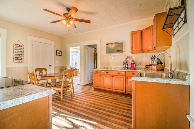 56 Andover St, Ludlow, VT 05149 - kitchen with a sink, light wood finished floors, ceiling fan, light countertops, and brown cabinets