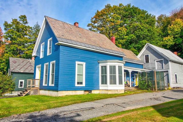 56 Andover St, Ludlow, VT 05149 - back of property featuring a chimney, a lawn, a standing seam roof, and a porch