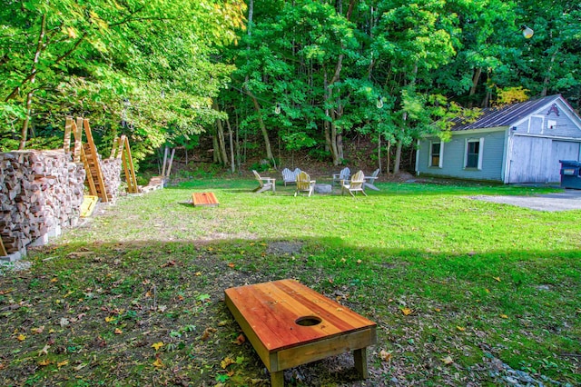 56 Andover St, Ludlow, VT 05149 - view of green lawn featuring an outdoor structure and a fire pit