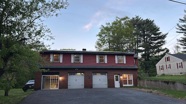7 Pond Rd, Derry, NH 03038 - view of front facade featuring asphalt driveway, an attached garage, and brick siding