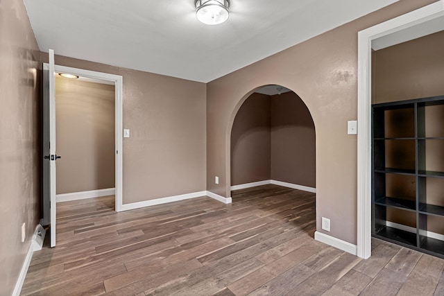 7 Pond Rd, Derry, NH 03038 - unfurnished room featuring wood finished floors, arched walkways, and baseboards