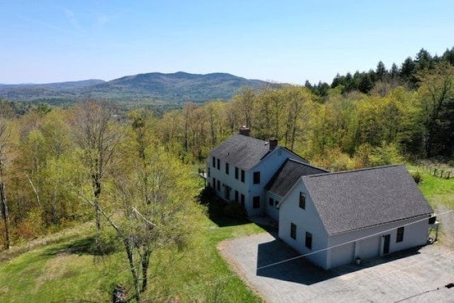 view of subject property featuring a heavily wooded area
