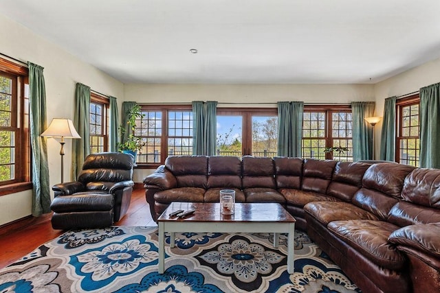 living area with wood finished floors and baseboards
