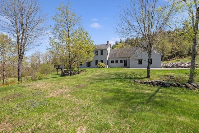 view of green lawn featuring a garage