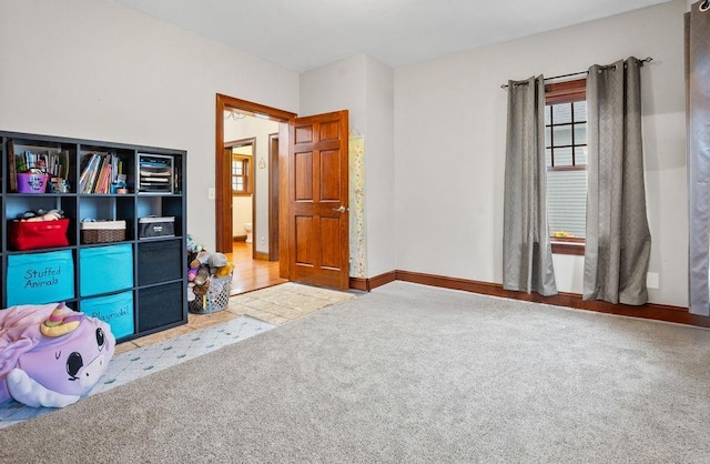 game room featuring carpet and baseboards