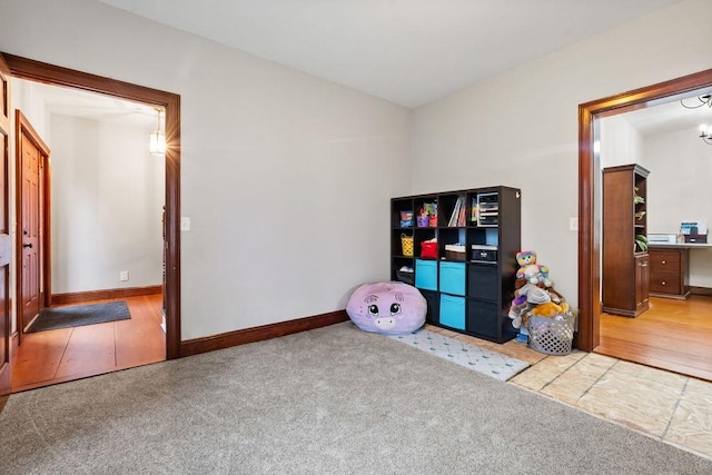 rec room featuring carpet floors and baseboards