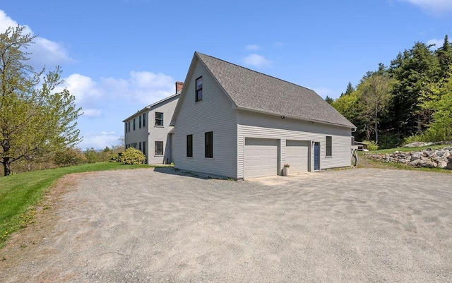 view of side of property with a chimney and a shingled roof