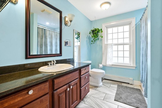bathroom with baseboard heating, healthy amount of natural light, toilet, and vanity