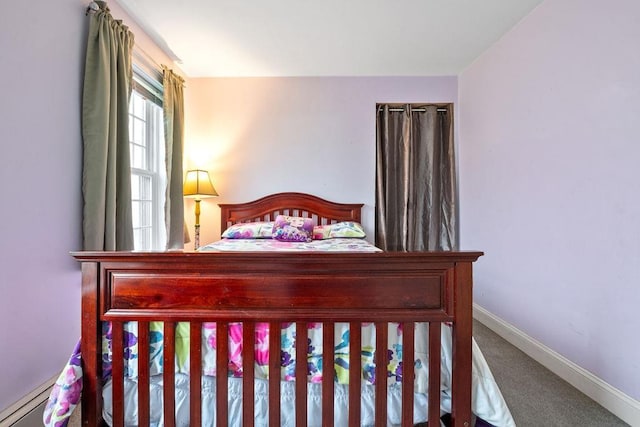 bedroom with baseboards and carpet