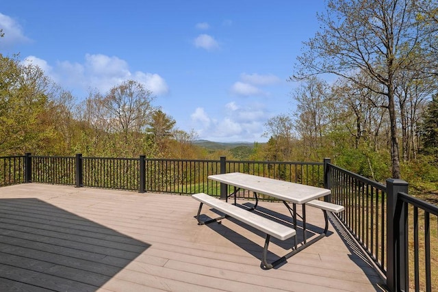 wooden deck featuring outdoor dining area