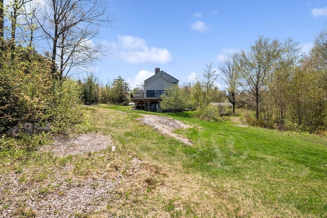 view of grassy yard featuring a wooden deck