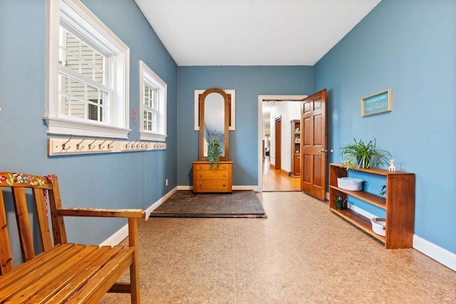 entrance foyer with baseboards and tile patterned floors