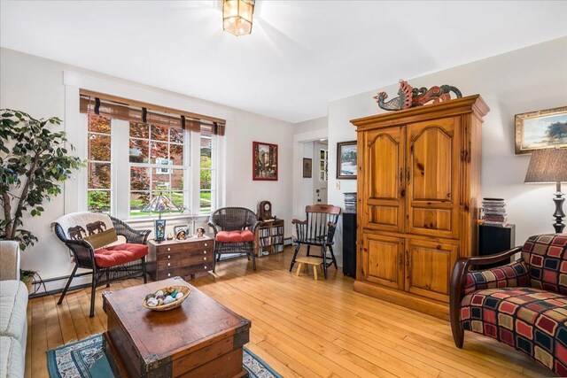 67 Kidder St, Manchester, NH 03101 - living room with light wood-style flooring and a baseboard heating unit