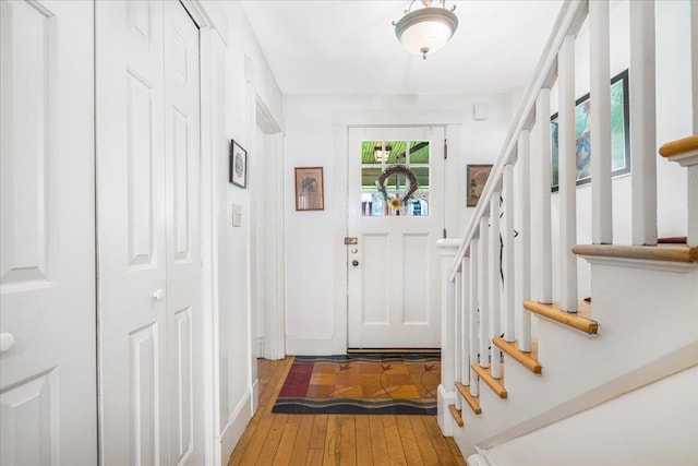 67 Kidder St, Manchester, NH 03101 - foyer entrance with light wood-style floors and stairway