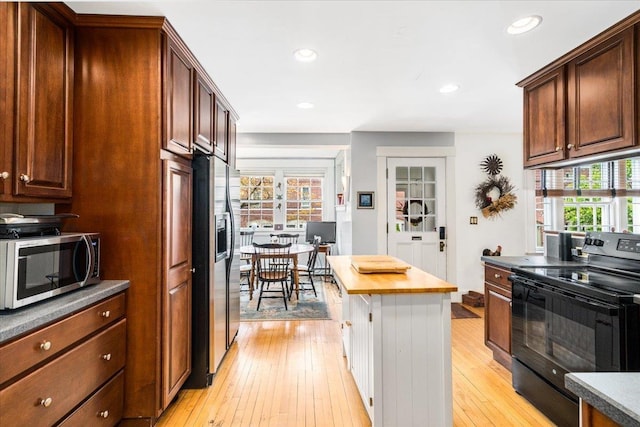 67 Kidder St, Manchester, NH 03101 - kitchen with stainless steel appliances, light wood-style floors, recessed lighting, and butcher block countertops