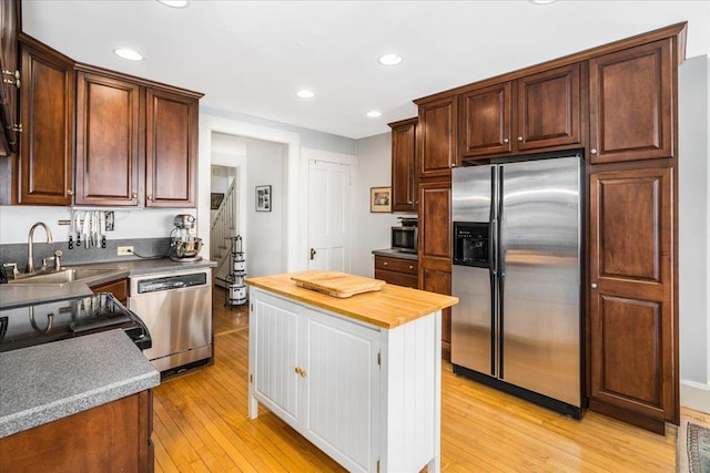 67 Kidder St, Manchester, NH 03101 - kitchen featuring appliances with stainless steel finishes, a sink, light wood-style flooring, butcher block countertops, and recessed lighting