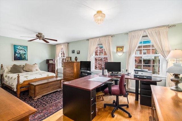 67 Kidder St, Manchester, NH 03101 - bedroom with light wood-style flooring, a desk, and a baseboard radiator