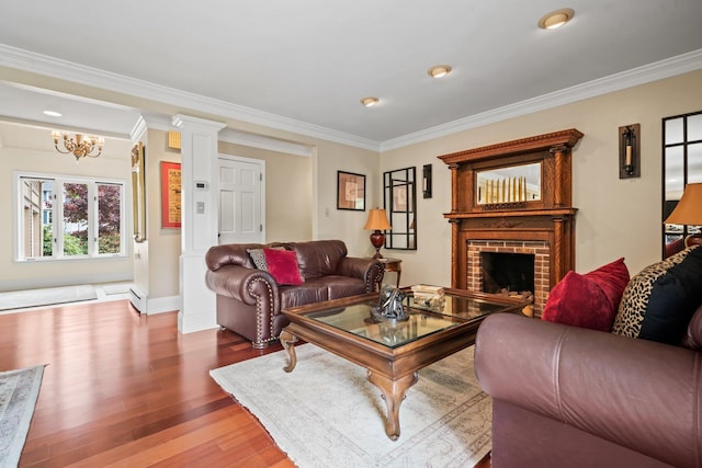 25 Golden Gate Dr, Hooksett, NH 03106 - living area with wood finished floors, ornamental molding, a chandelier, a brick fireplace, and baseboards