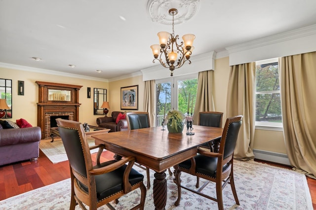 25 Golden Gate Dr, Hooksett, NH 03106 - dining room with wood finished floors, a chandelier, healthy amount of natural light, and ornamental molding
