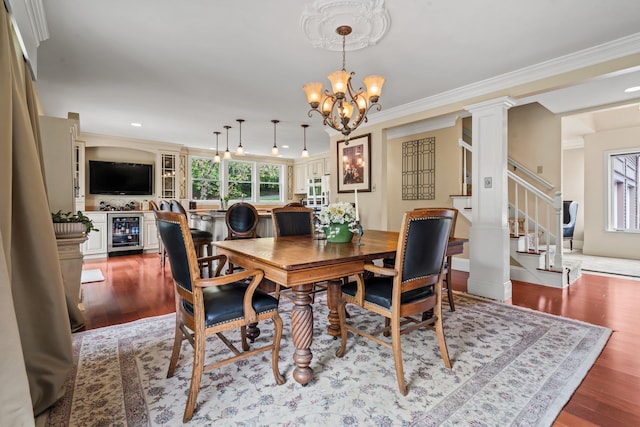 25 Golden Gate Dr, Hooksett, NH 03106 - dining room featuring wine cooler, a chandelier, stairs, wood finished floors, and ornamental molding