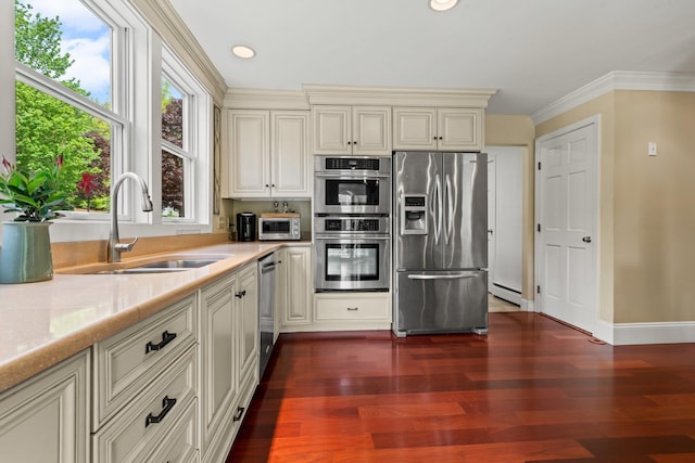 25 Golden Gate Dr, Hooksett, NH 03106 - kitchen featuring appliances with stainless steel finishes, a sink, cream cabinets, light countertops, and dark wood-type flooring